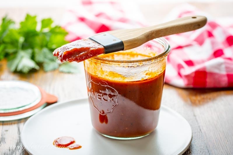 Homemade Honey BBQ Sauce in a jar with a brush for slathering