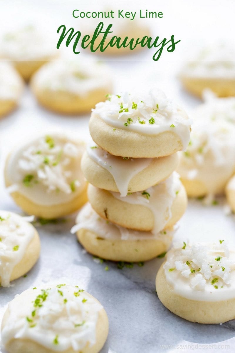 A stack of key lime coconut meltaway cookies topped with shredded coconut and key lime zest