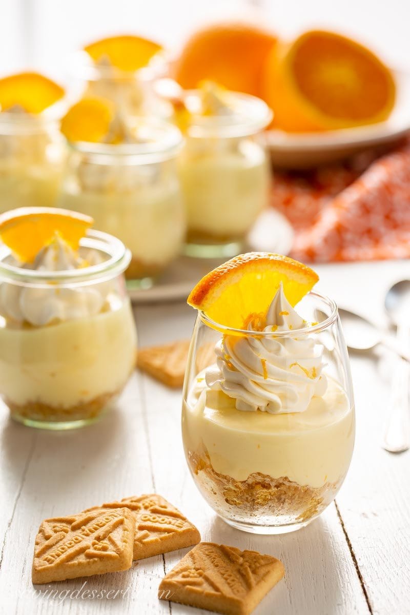 No-Bake Cheesecake in a jar with shortbread cookies and orange wedges