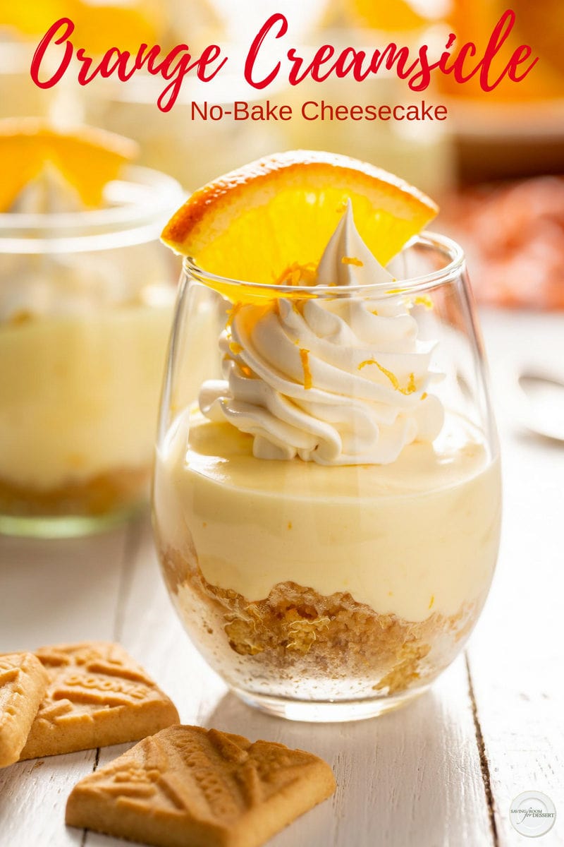 A jar filled with crushed cookies and a fluffy orange no-bake cheesecake filling