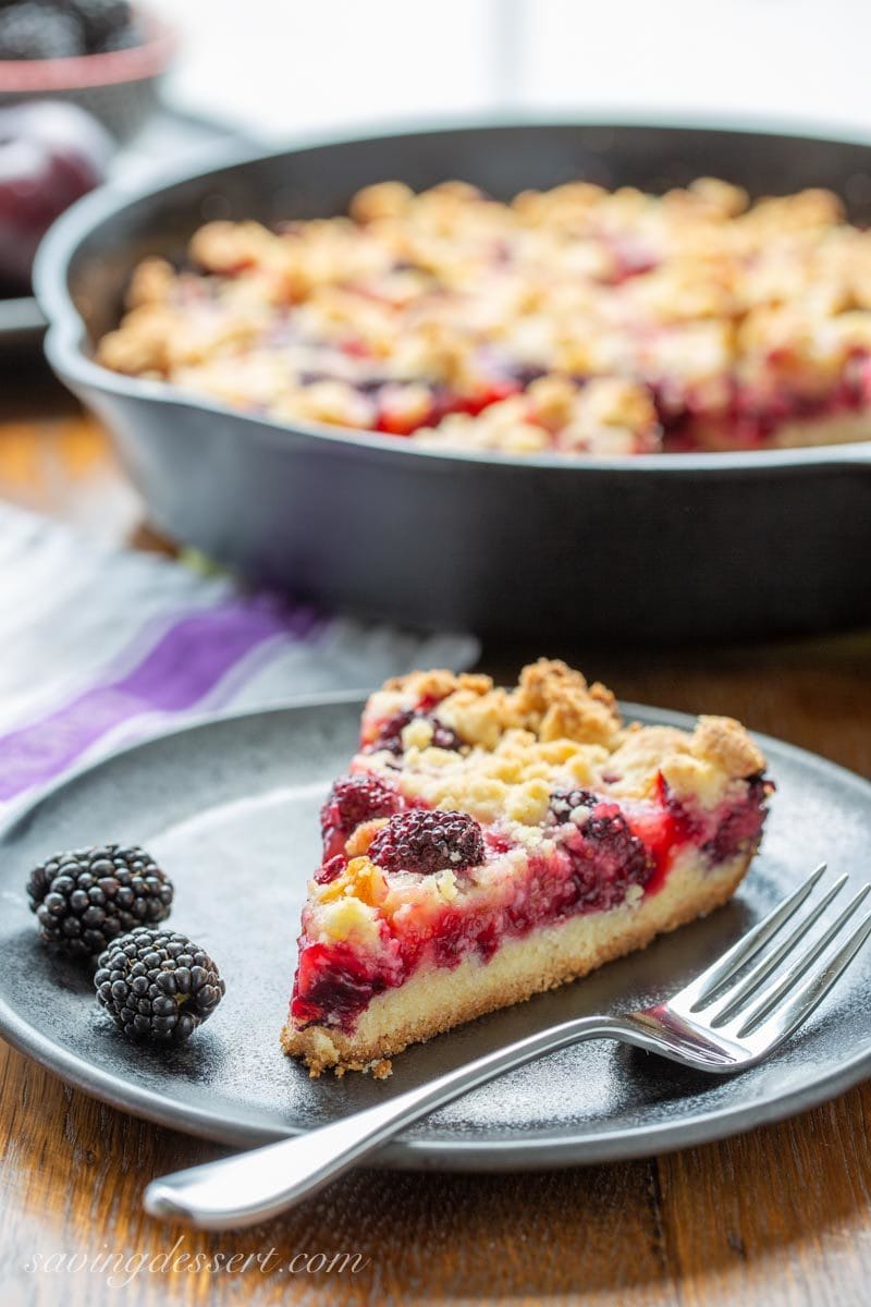 A slice of plum and blackberry bars on a plate