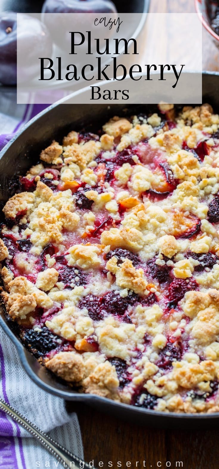 A cast iron skillet filled with blackberry plum crumble bars