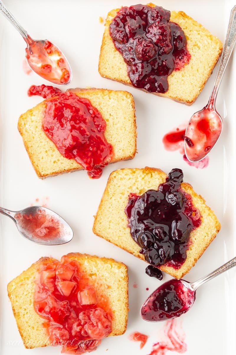 sliced lemon pound cake with blackberry, raspberry, blueberry and strawberry sauces