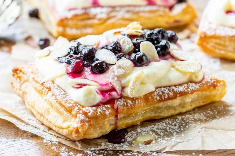 Blueberry Puff Pastry Tarts with Lemon Cream, almonds and powdered sugar dusted on top