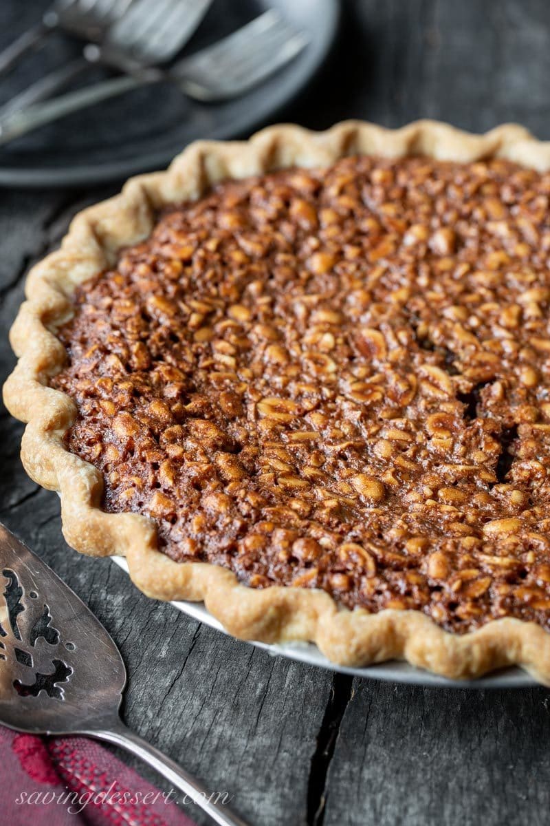 A side view of a rustic chocolate peanut pie