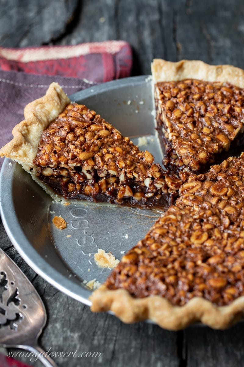 A pie plate with sliced chocolate peanut pie