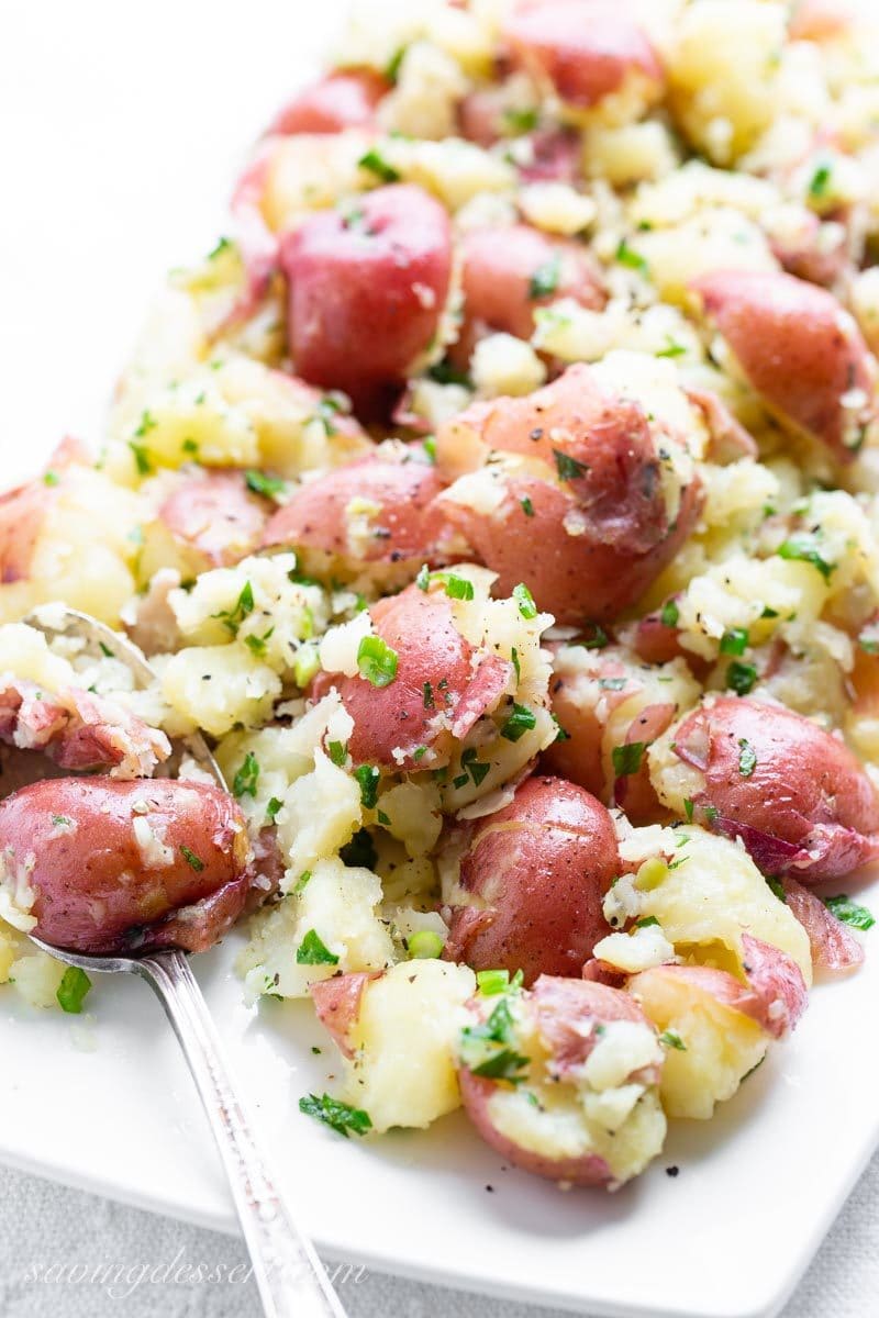 Garlic herb smashed red potatoes on a platter