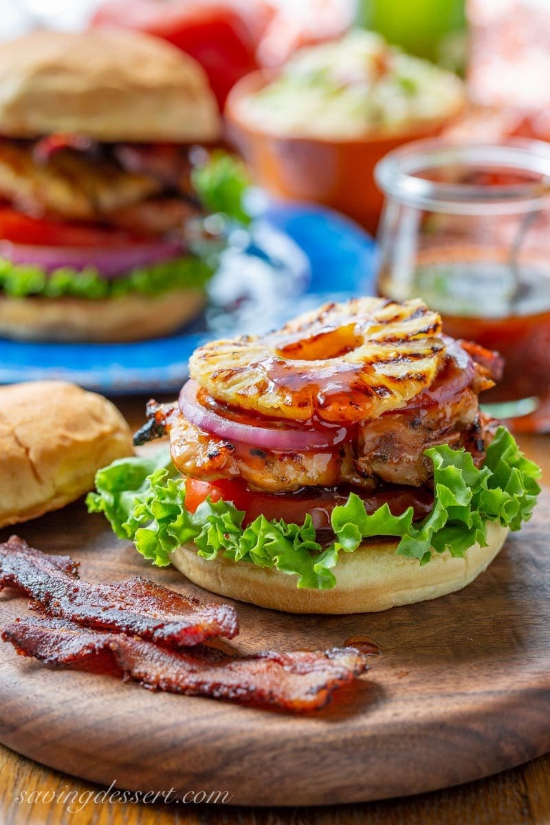 Grilled Hawaiian Chicken Sandwich with pineapple, black pepper bacon and a sticky sweet pineapple sauce, with lettuce, tomato and onion