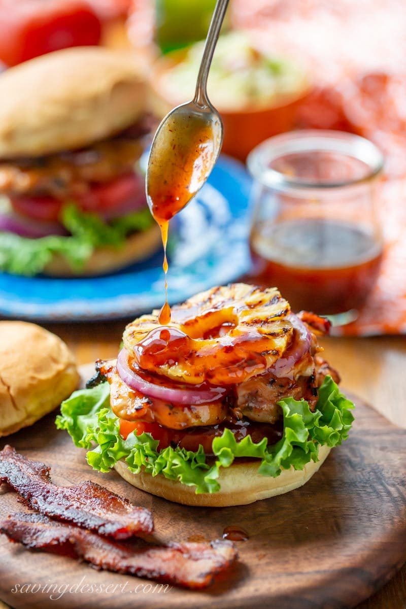 A drizzle of sauce on our Grilled Hawaiian Chicken Sandwich with pineapple, black pepper bacon with lettuce, tomato and onion