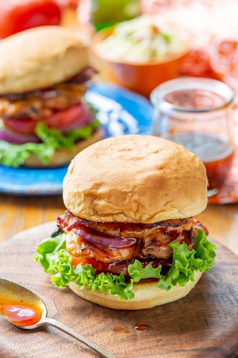 Grilled Hawaiian Chicken Sandwich with pineapple, black pepper bacon and a sticky sweet pineapple sauce, with lettuce, tomato and onion