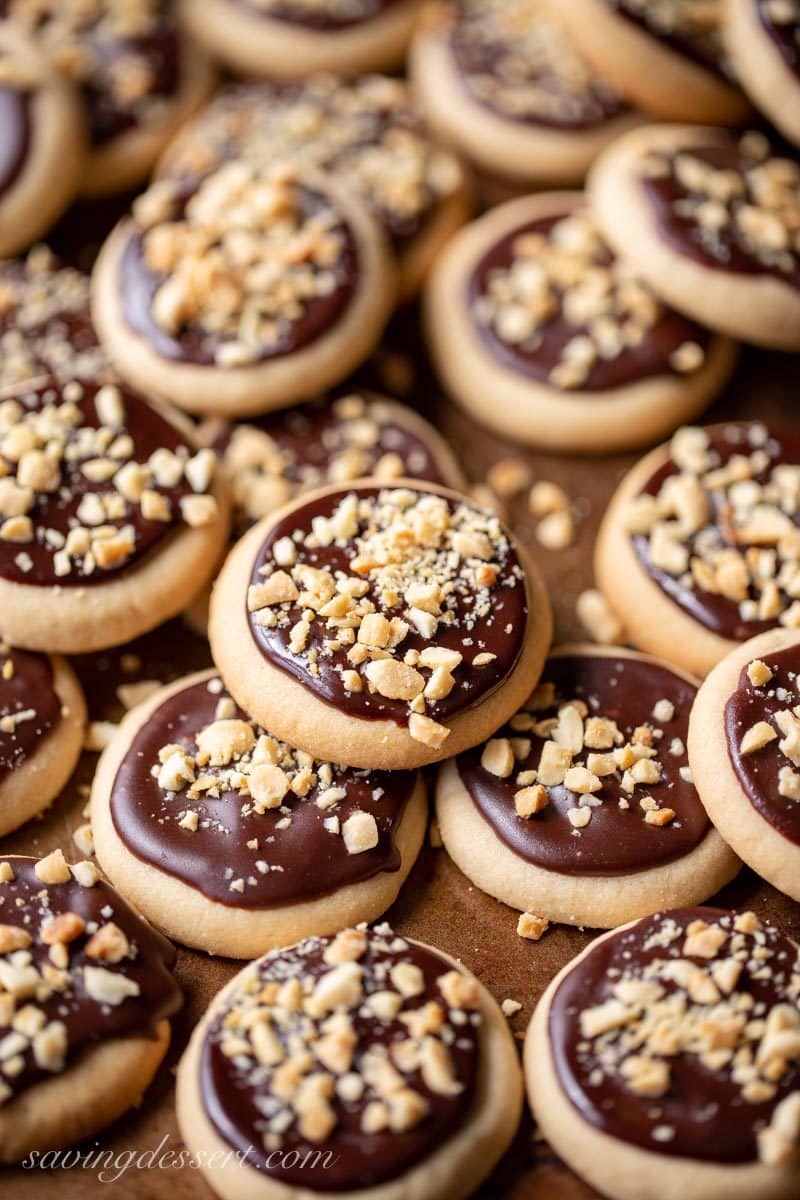 A cookie sheet full of peanut butter chocolate meltaway cookies with chopped peanuts on top