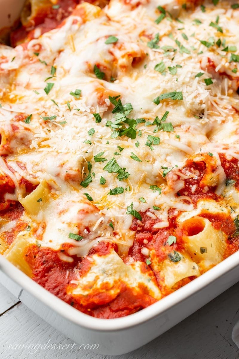 Rigatoni pasta with marinara sauce, cheese and fresh parsley on top