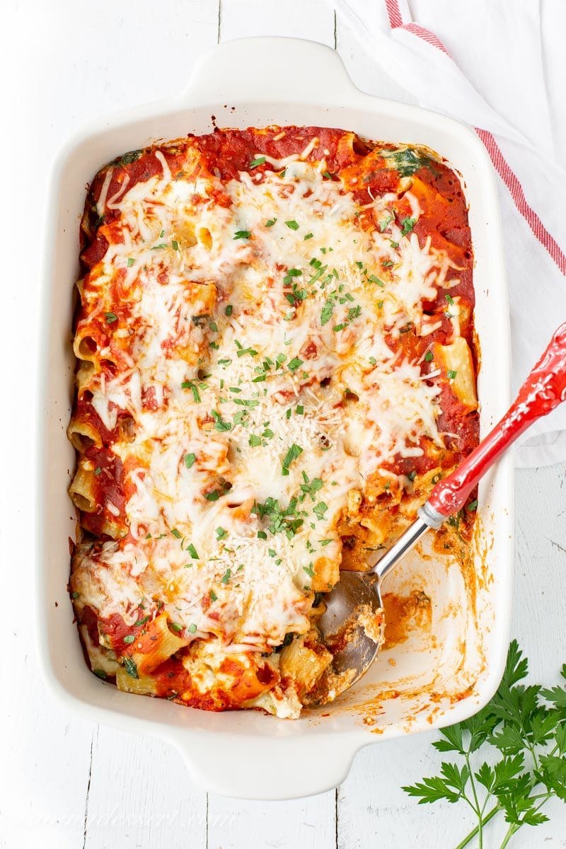 A large casserole dish with Ricotta & Spinach Pasta Bake sprinkled with fresh parsley