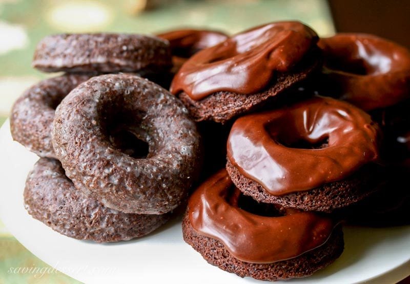A platter of chocolate cake doughnuts with a buttermilk glaze or chocolate icing