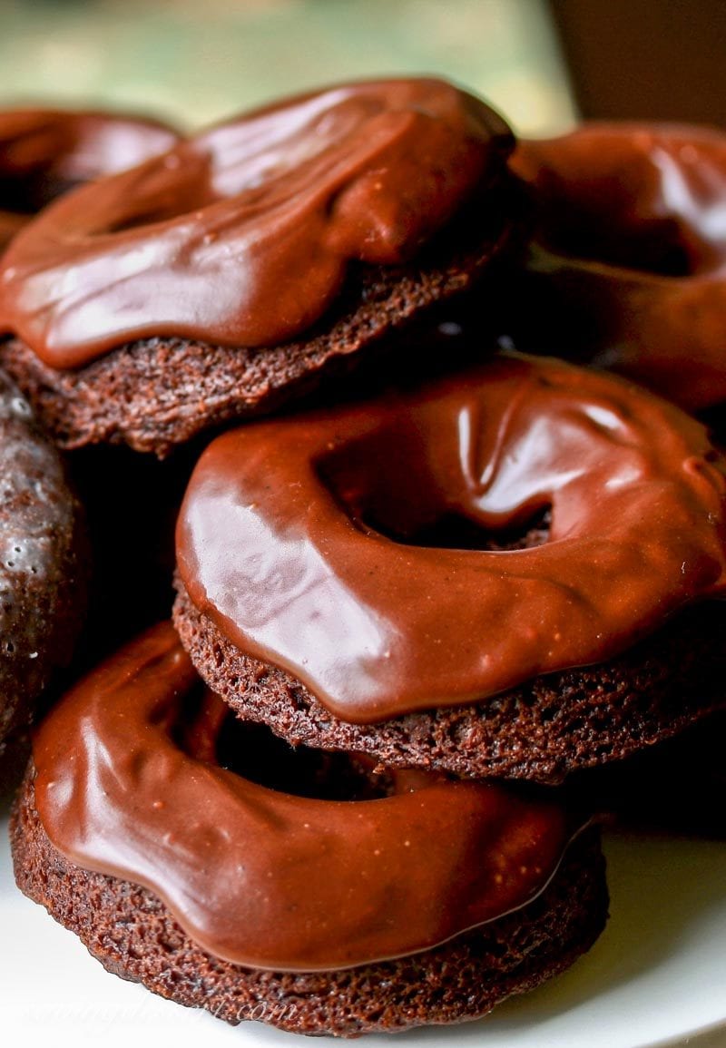 A stack of chocolate glazed chocolate doughnuts