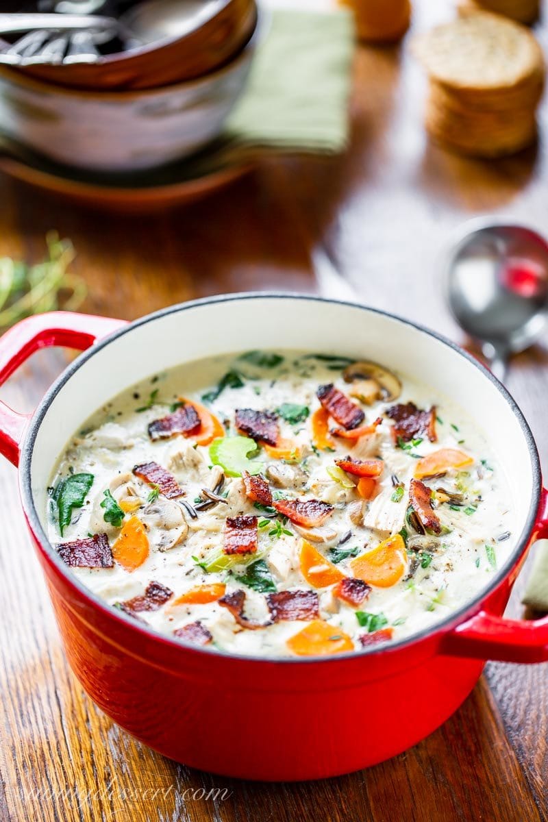 Red Dutch oven with creamy chicken and wild rice soup