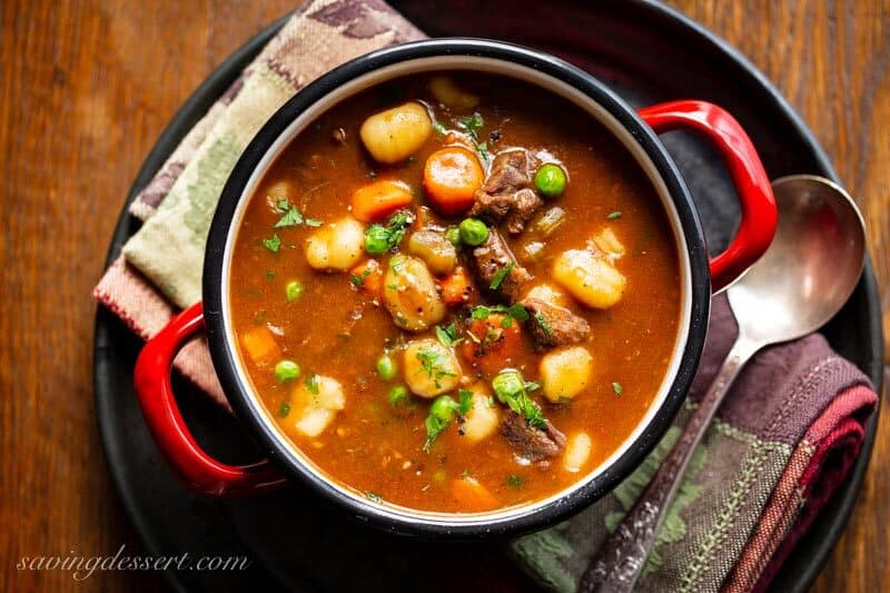 An overhead view of a bowl of beef and gnocchi soup