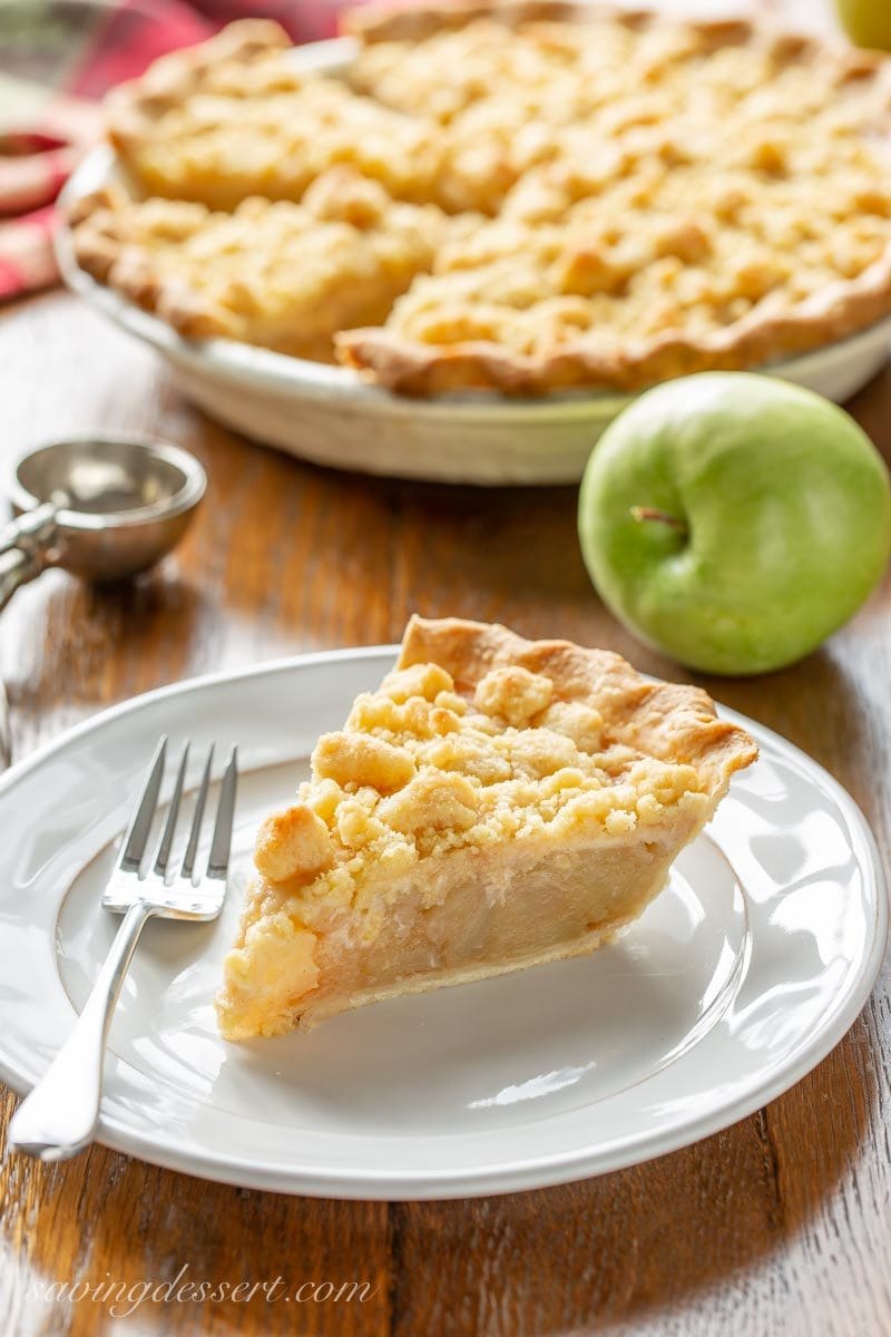 A slice of Dutch Apple Pie with buttery, crunchy streusel topping