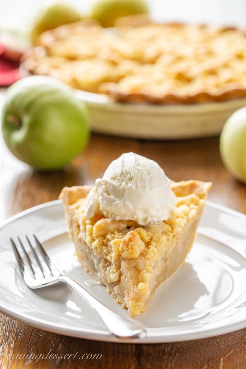 A slice of Dutch Apple Pie with a scoop of vanilla ice cream