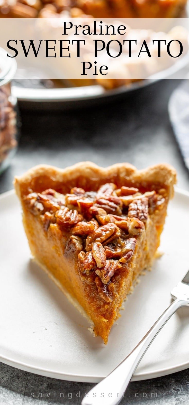 A slice of praline sweet potato pie on a plate covered with pecans