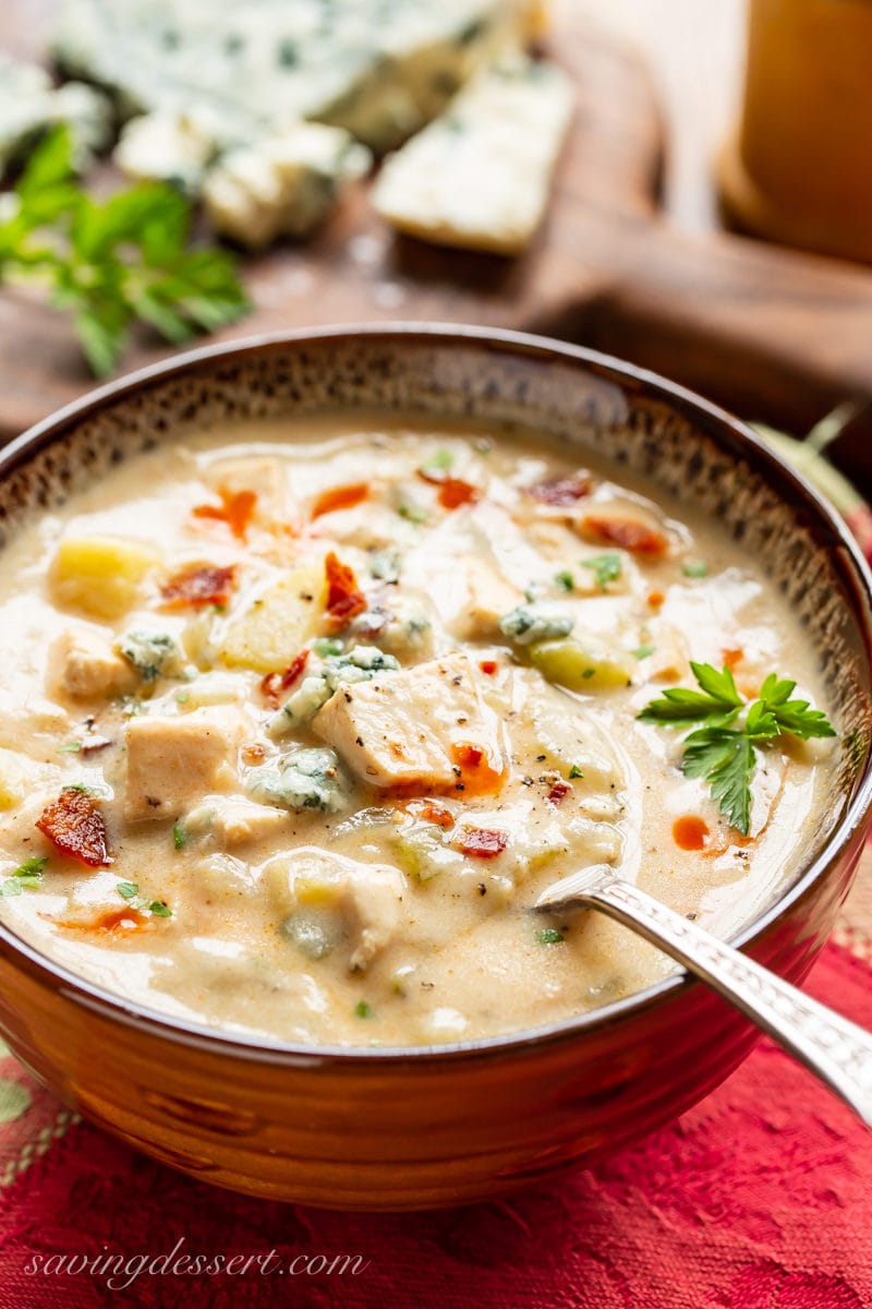 A bowl of Buffalo Chicken Chowder with bacon, blue cheese and parsley