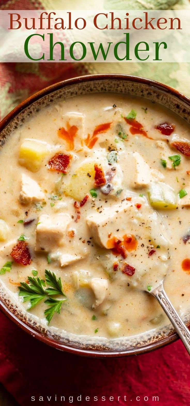 An overview view of a bowl of Buffalo chicken chowder garnished with bacon and hot sauce