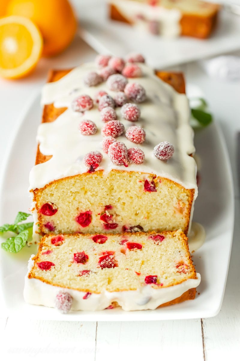 A loaf of cranberry orange bread with sugared cranberries on top