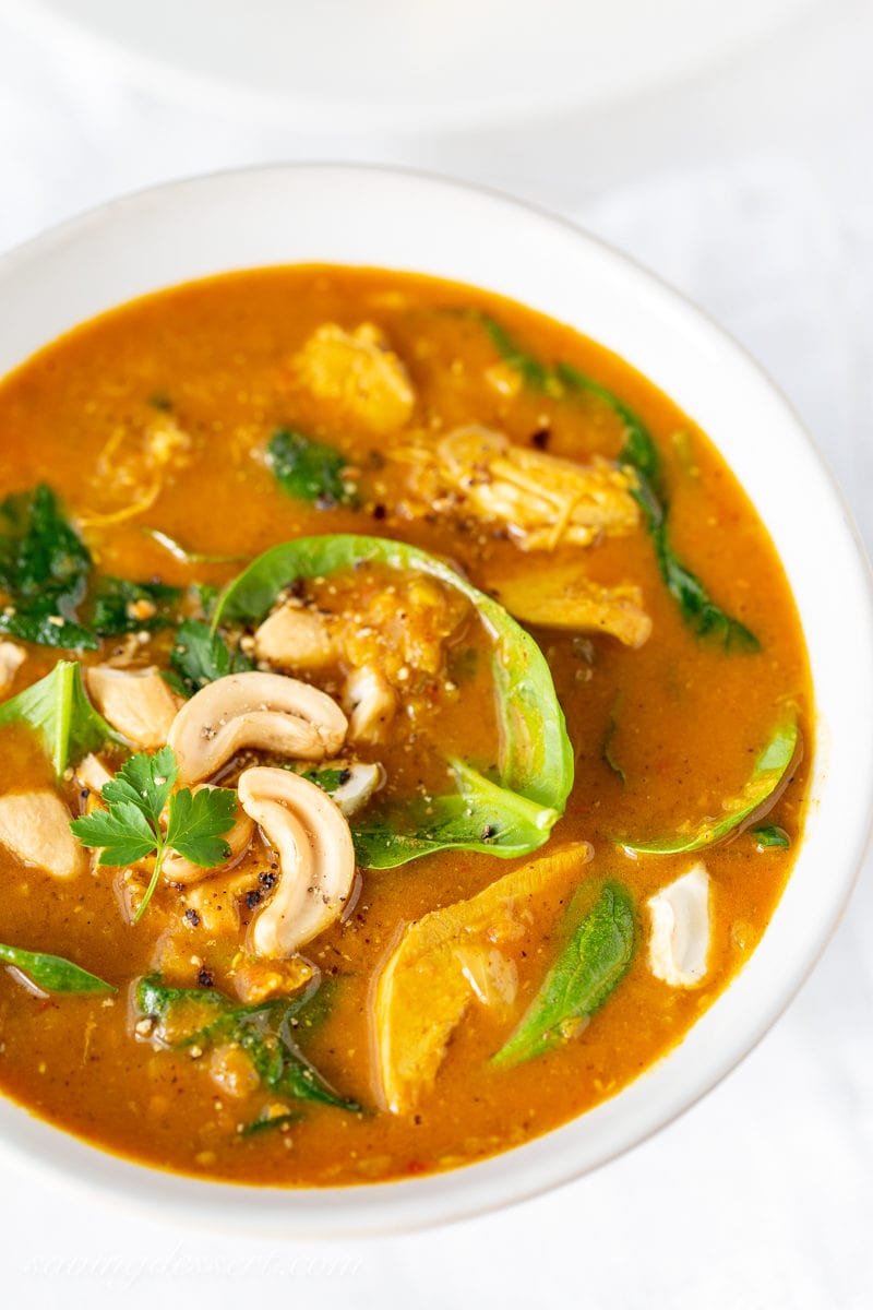 A bowl of creamy chicken soup with lentils and spinach