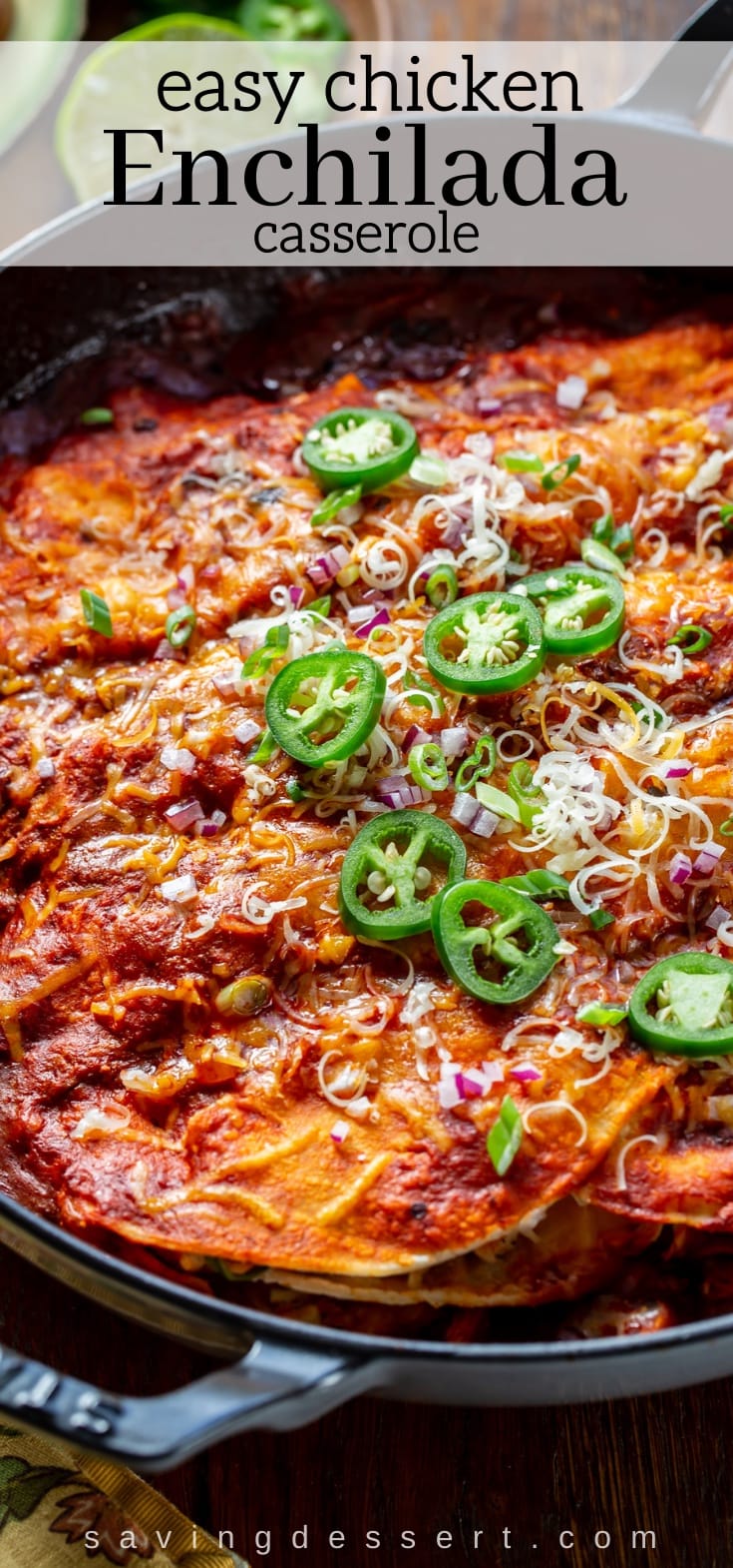 A cast iron skillet filled with cheesy chicken enchiladas