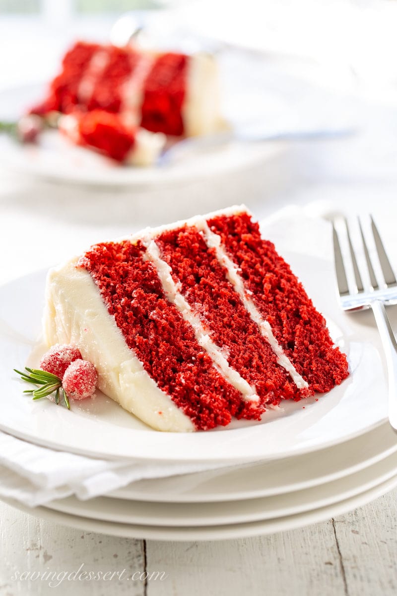 A slice of red velvet cake with cream cheese icing