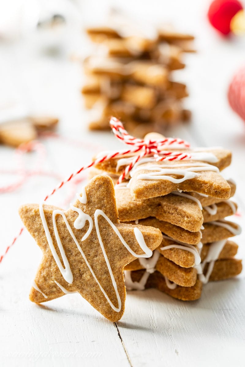 A stack of star shaped Speculaas Cookies with a simple drizzled icing