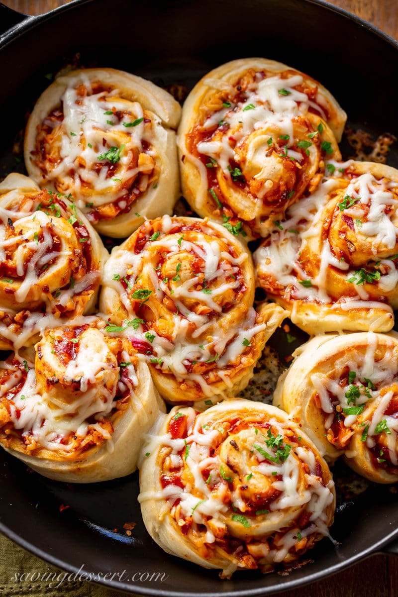 An overhead view of Cheesy BBQ Chicken Pizza Rolls in a skillet