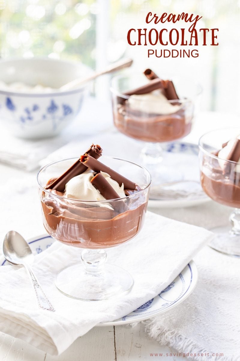 Bowls of homemade Chocolate Pudding topped with whipped cream and chocolate curls