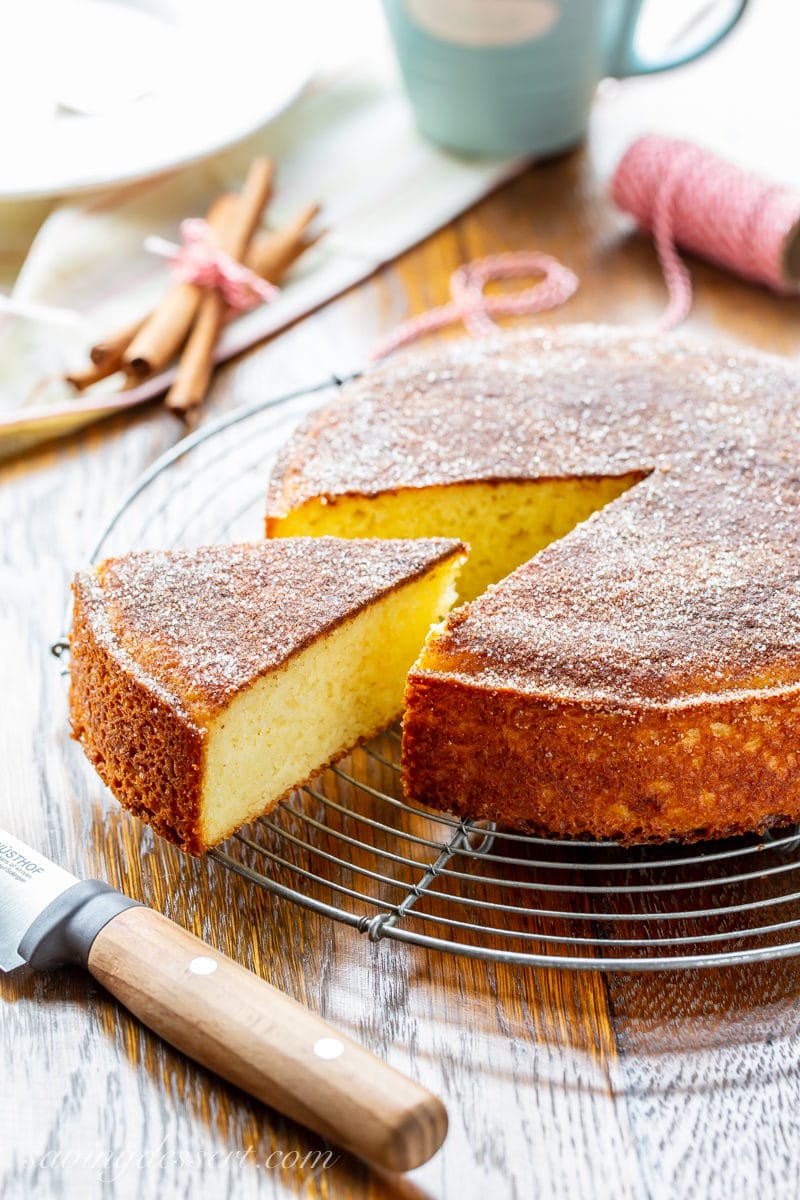 A sliced cinnamon breakfast cake on a cooling rack