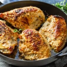 A skillet filled with Oven-Roasted Greek Chicken Breasts