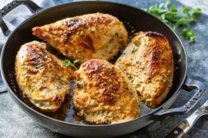 A skillet filled with Oven-Roasted Greek Chicken Breasts