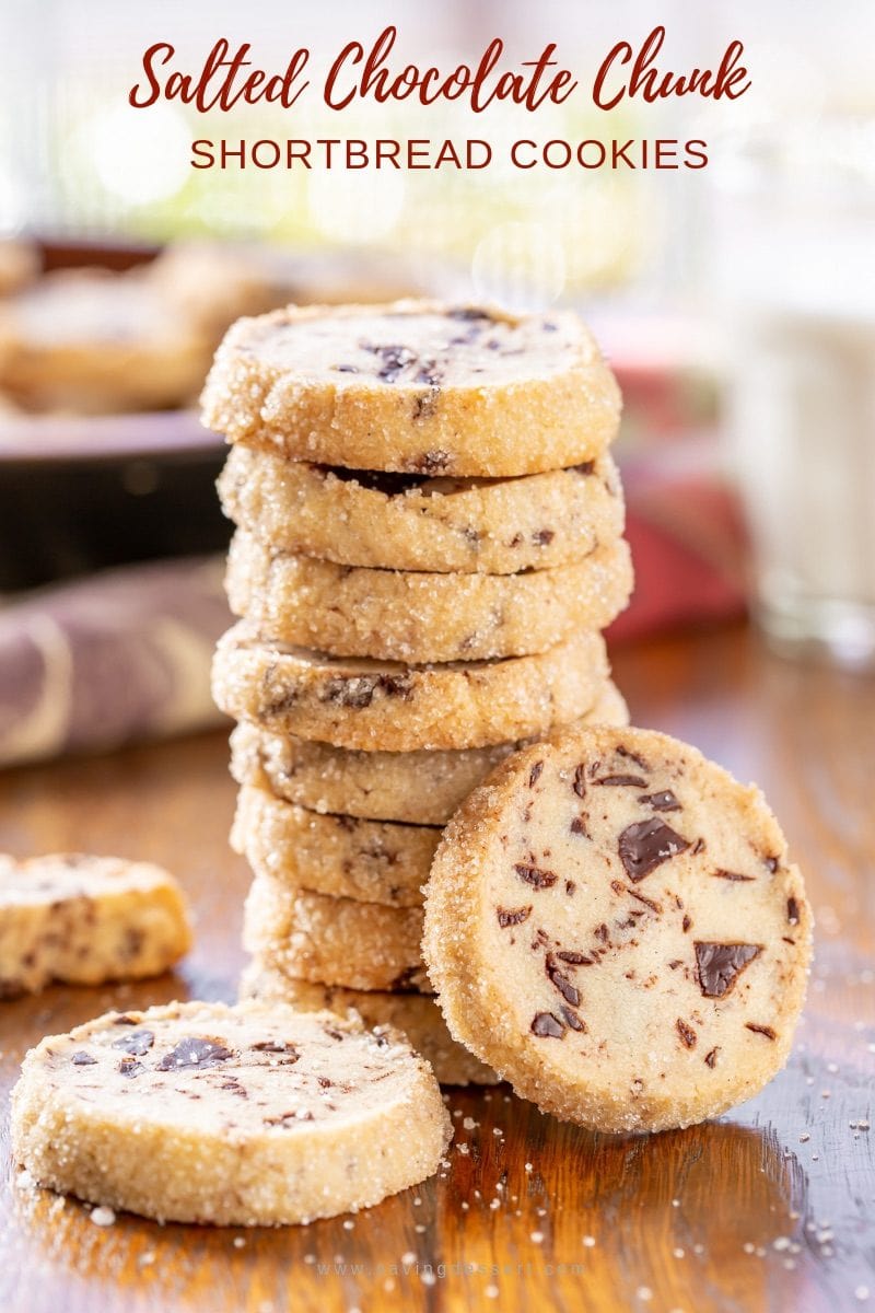 A stack of Salted Chocolate Chunk Shortbread Cookies with a sprinkling of sea salt