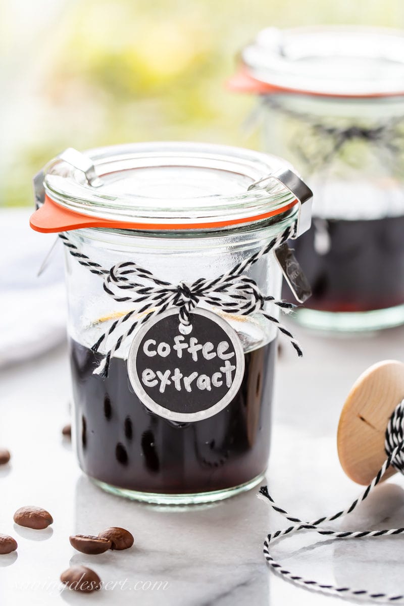 Homemade coffee extract in a jar with coffee beans