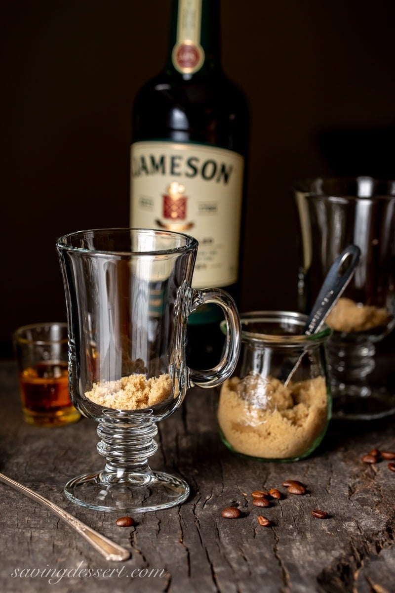 Mugs with brown sugar as the first step in making Irish Coffee