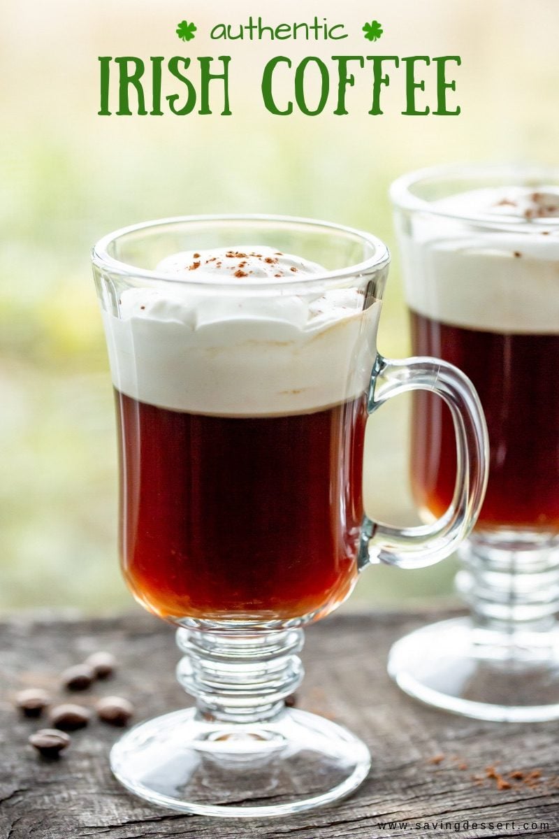 Mugs of hot Irish Coffee with soft whipped cream on top