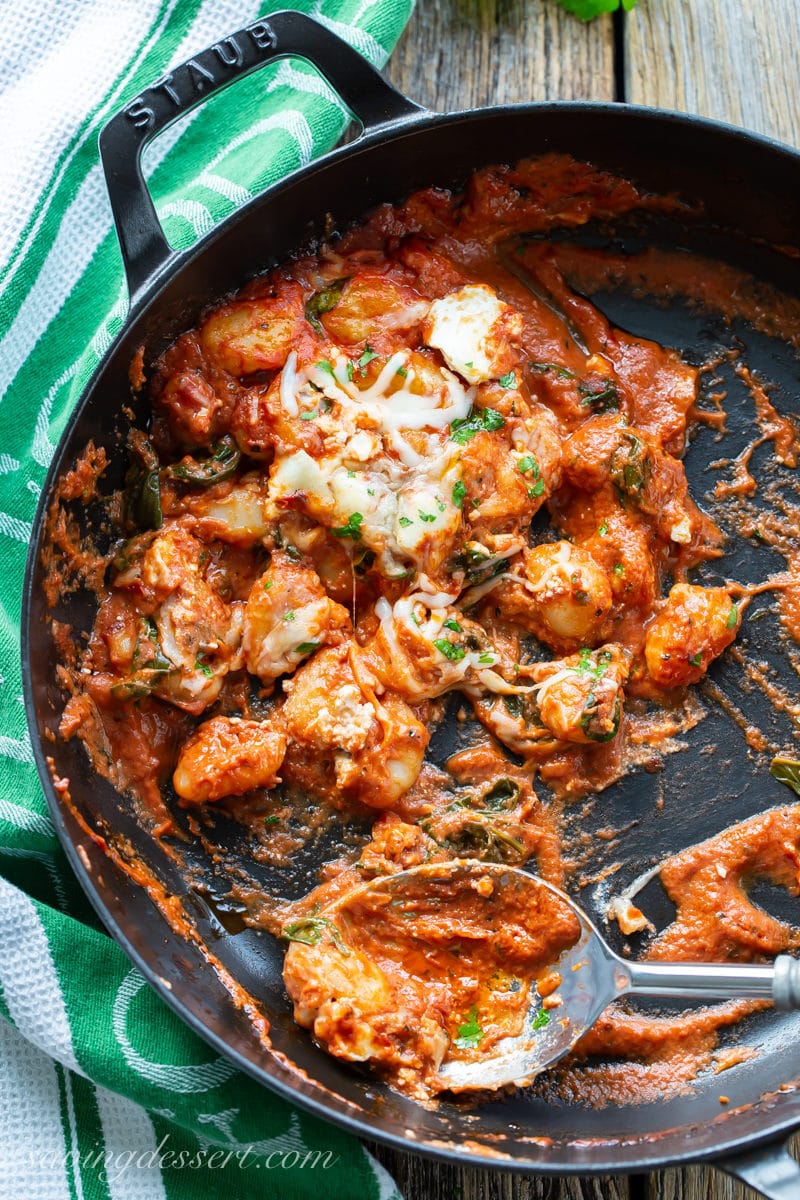 A half empty skillet of baked tomato gnocchi with three cheeses