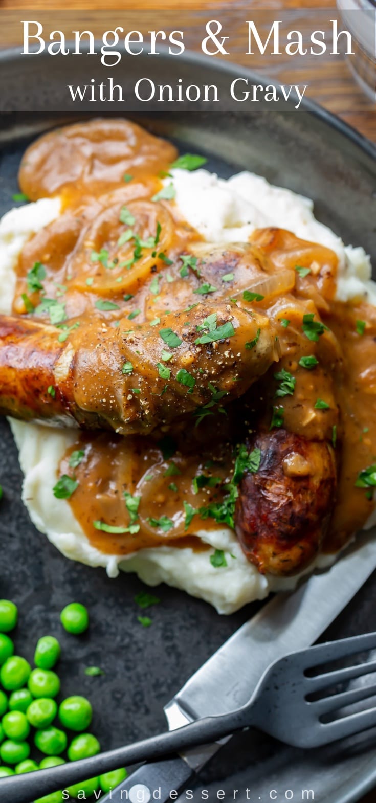 A plate of Bangers and Mash with peas