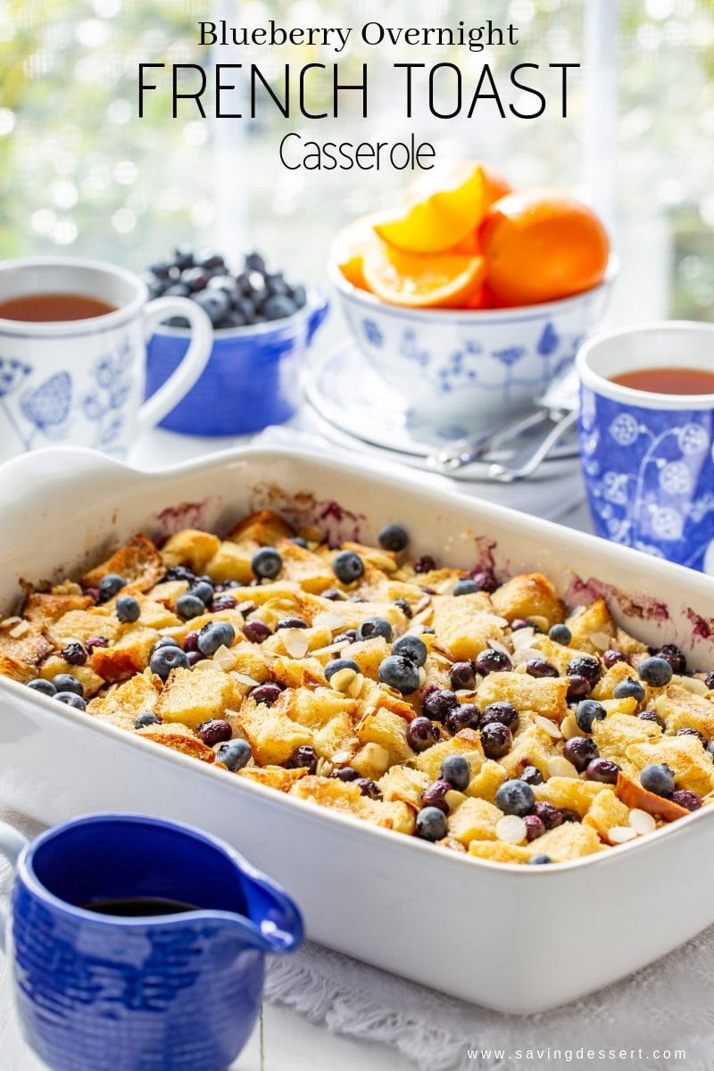 Blueberry Overnight French Toast Casserole - anybody can make this delicious weekend brunch favorite easily assembled the night before then baked in the morning. #frenchtoast #blueberrycasserole #blueberryfrenchtoast #breakfastcasserole #overnightcasserole ##blueberryfrenchtoastcasserole #overnight #brunch #breakfast #mothersday A Blueberry Overnight French Toast Casserole served with oranges