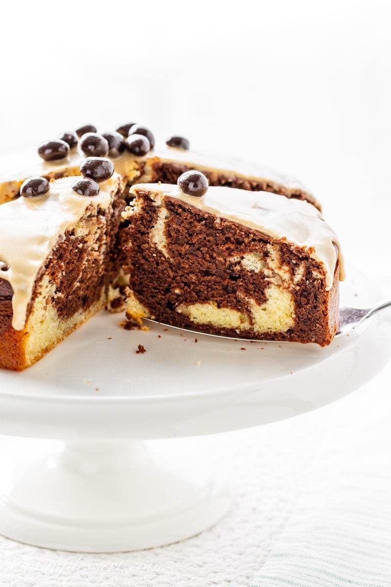 a chocolate marble cake, sliced and sitting on a cake stand