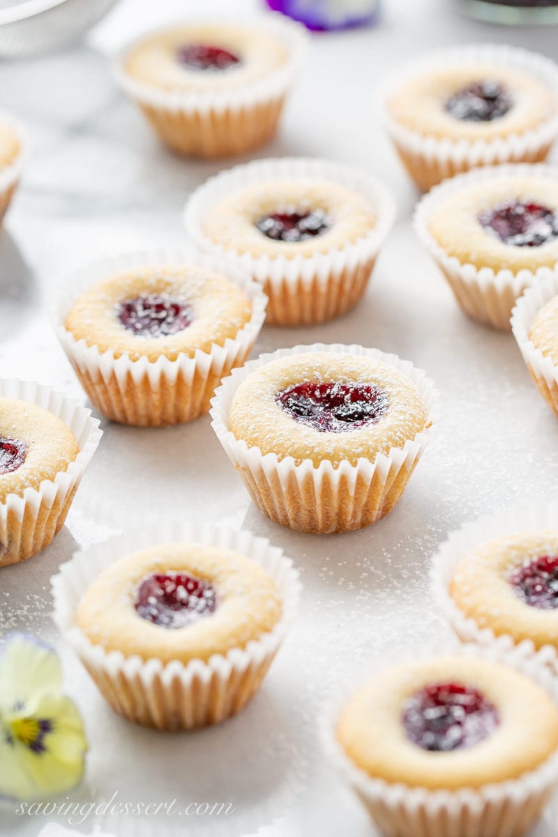 Almond Tea Cakes in mini paper cupcake liners with a wild blueberry jam center