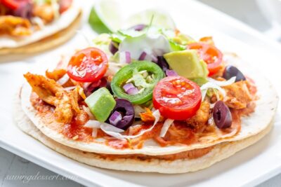 A platter of slowly Mexican Pizzas topped alongside avocado Easy Mexican Pizza