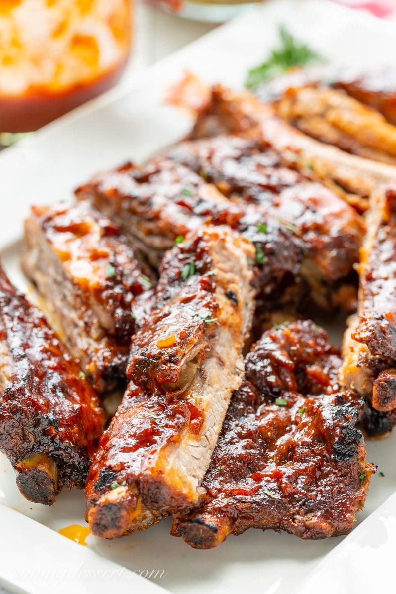 A platter filled with slow-cooker ribs slathered in homemade bbq sauce