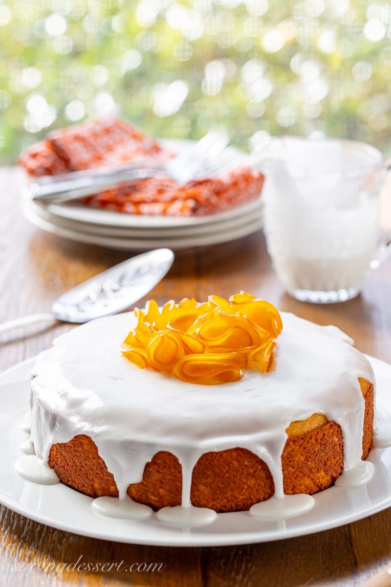 A one layer Sunny Citrus Cake topped with a simple icing and candied orange slices