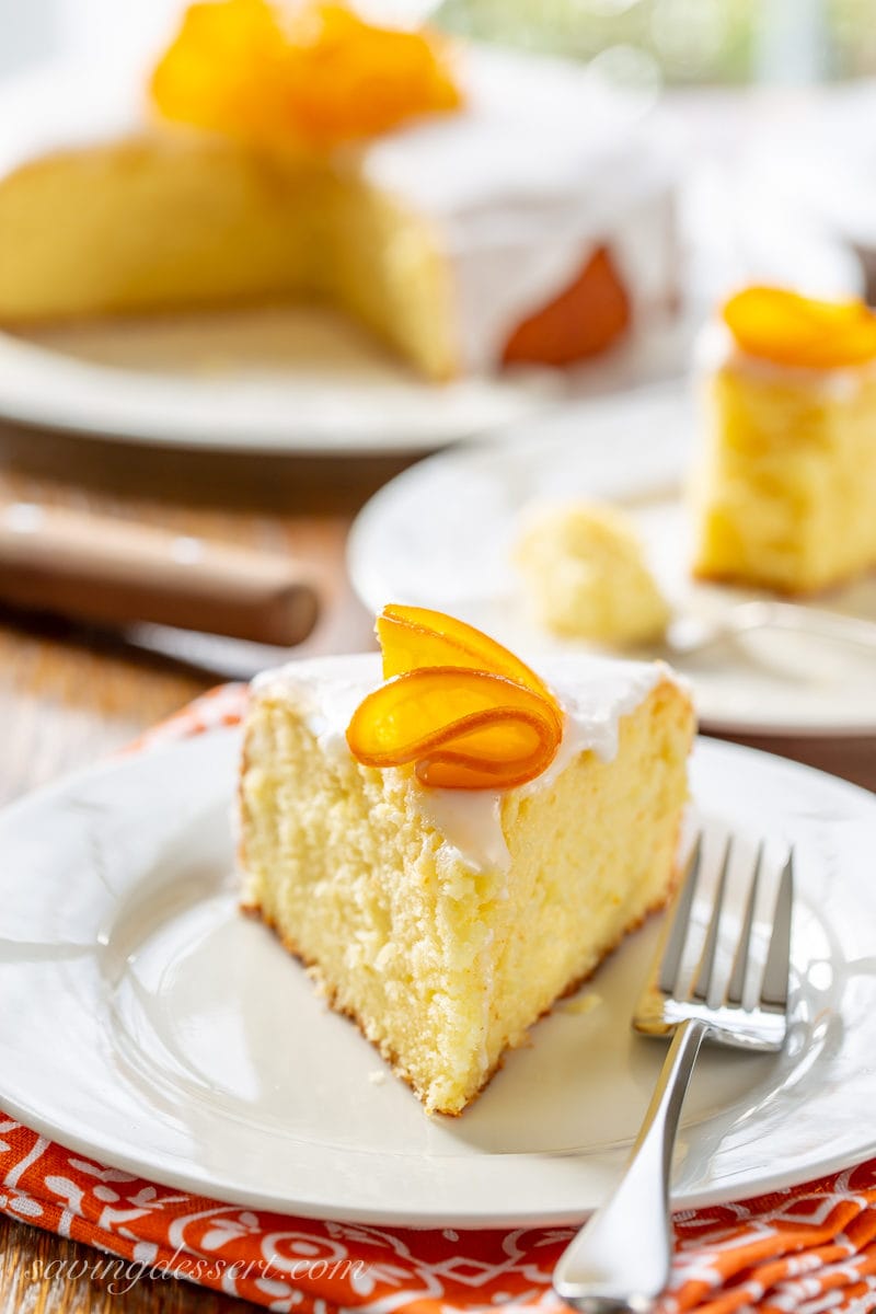 A slice of Sunny Citrus Cake with a candied orange on top