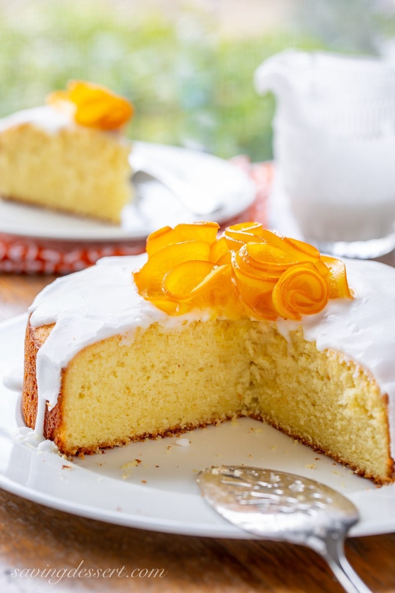 The inside of a Sunny Citrus Cake topped with icing and a group of candied orange slices